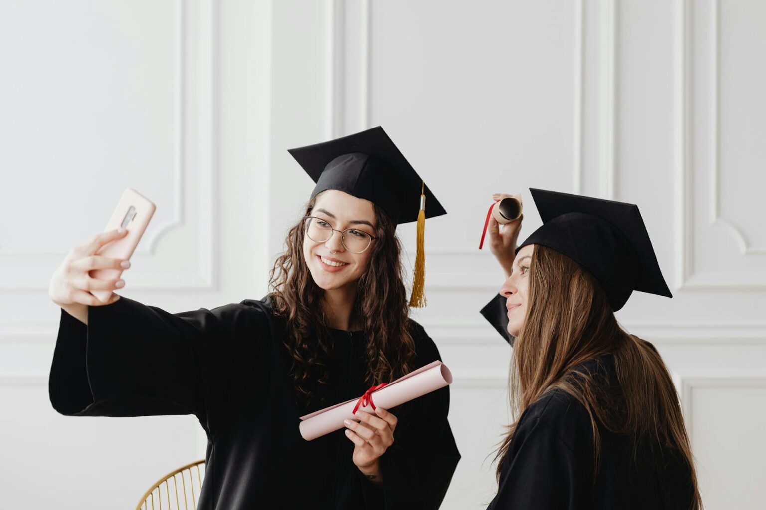 College graduates in caps and gowns celebrating at graduation ceremony