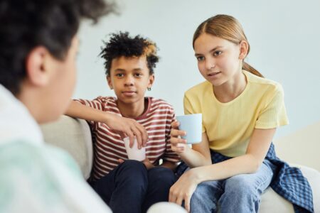 Group of diverse teenagers engaged in animated conversation, representing authentic social connection