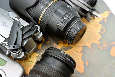 Comparing DJI Mini 4 Pro vs GoPro Hero 12 for Travel Content Professional drone and action camera equipment laid out for travel content creation