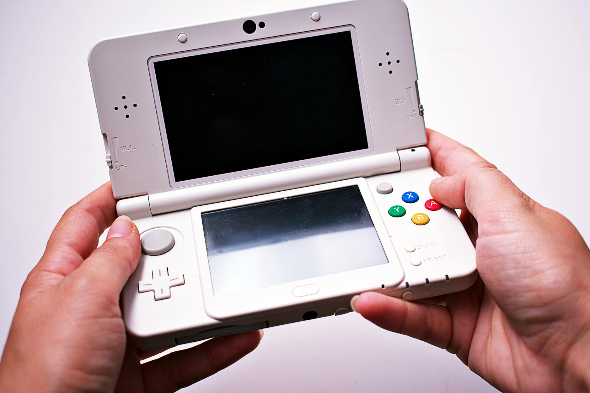 Portable gaming device on wooden surface showing handheld gaming setup