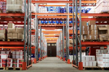 Why Former Uber Executives Are Building AI-Powered Logistics Companies Modern warehouse interior with organized shelving and logistics operations