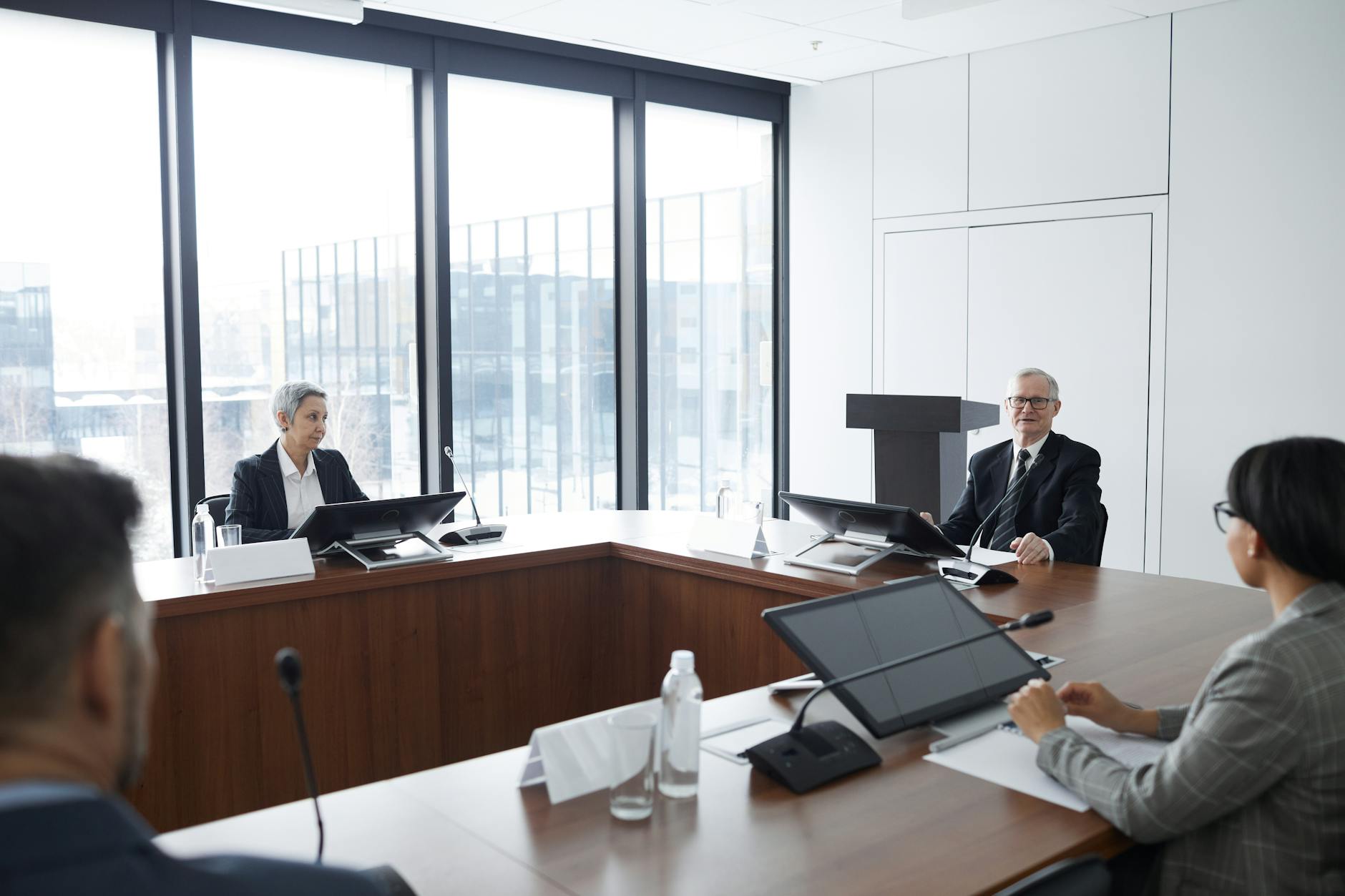 Professional business meeting with lawyers discussing documents around conference table