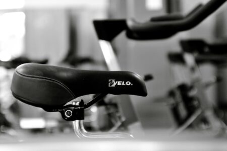 Comparing Peloton Bike Plus vs NordicTrack S22i for Home Fitness Modern stationary exercise bike with touchscreen display in home gym setting