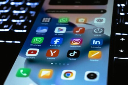 Person using smartphone to access social media apps and stories features