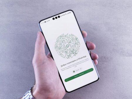 How WhatsApp’s Business API Changes Are Affecting Small Retailers Person using messaging app on smartphone for business communication