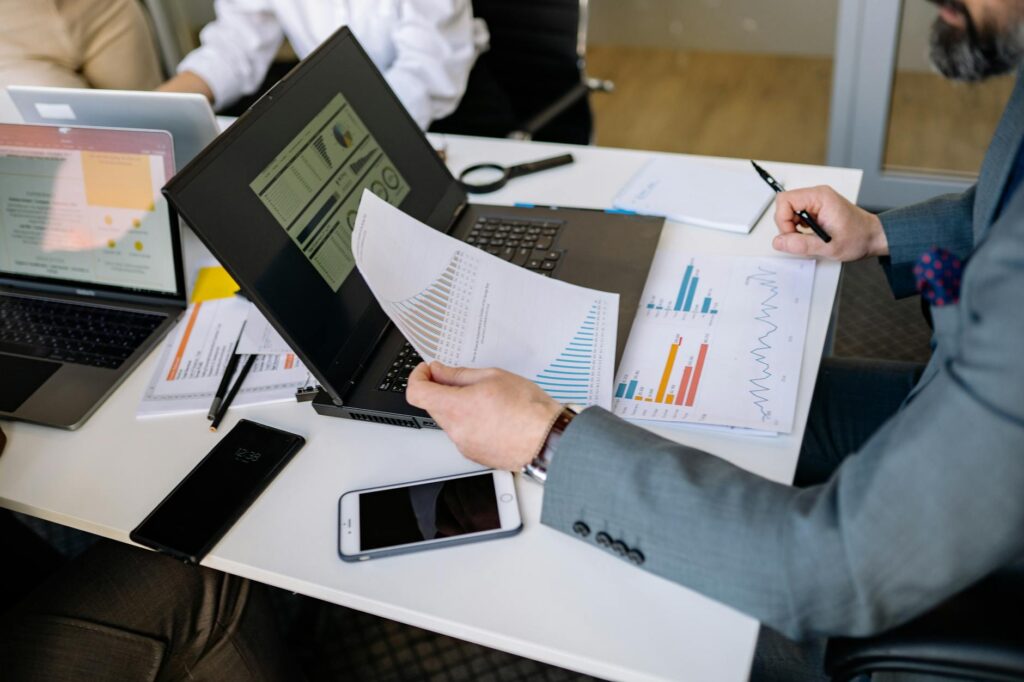 Professional using laptop in modern office setting for video call or recording