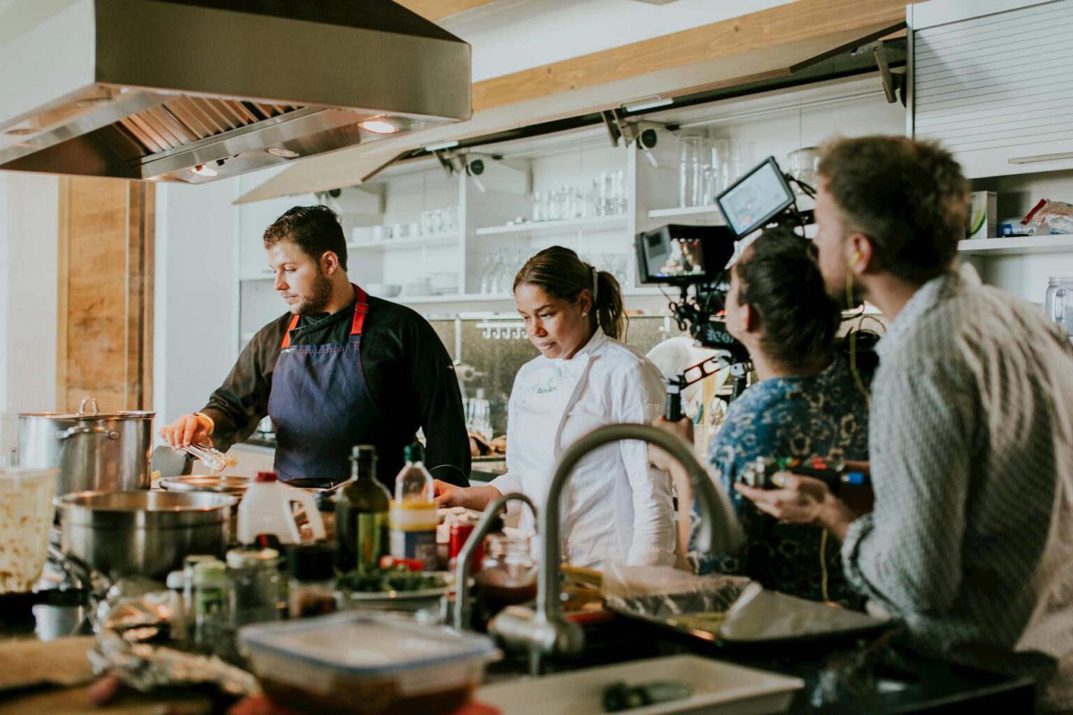 Professional chef in commercial kitchen during video call consultation