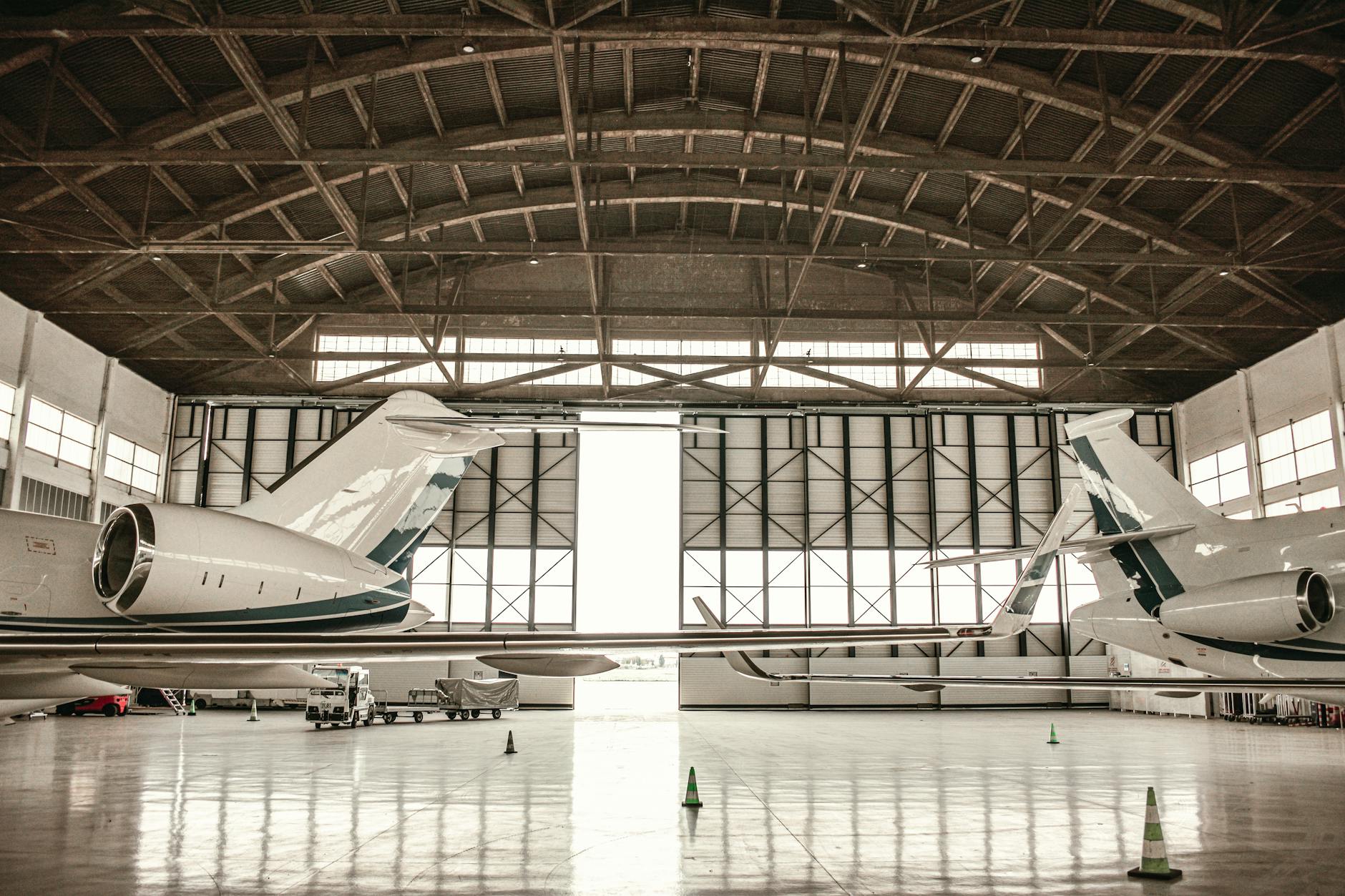 Aircraft maintenance technician working on airplane engine in hangar facility