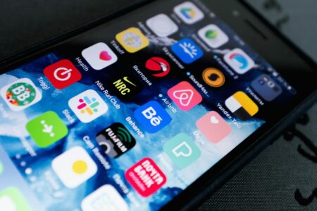 Close-up view of smartphone screen showing mobile app interface with clean, modern design elements