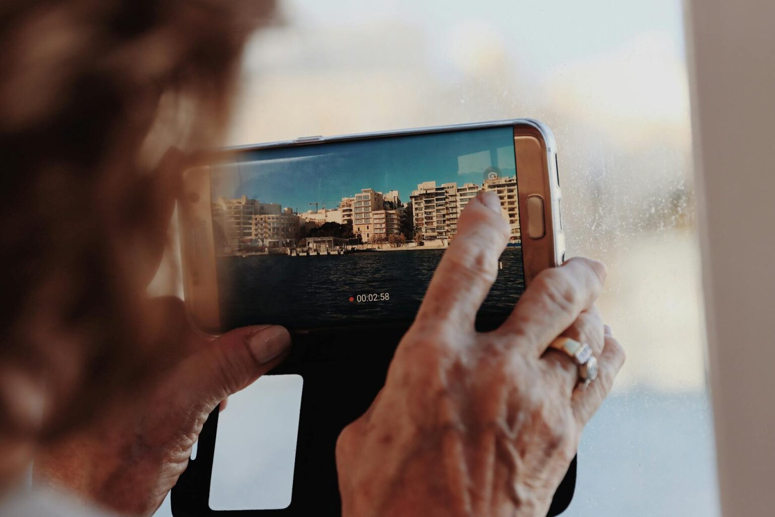 Person holding smartphone recording short-form video content for social media platform