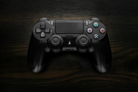 Modern gaming controller on dark surface representing portable gaming devices