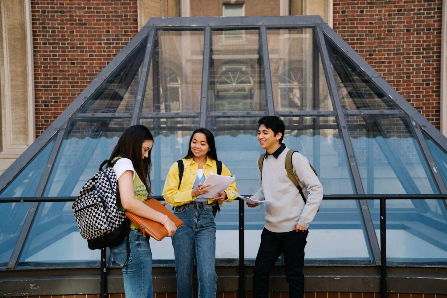 College students walking across university campus courtyard