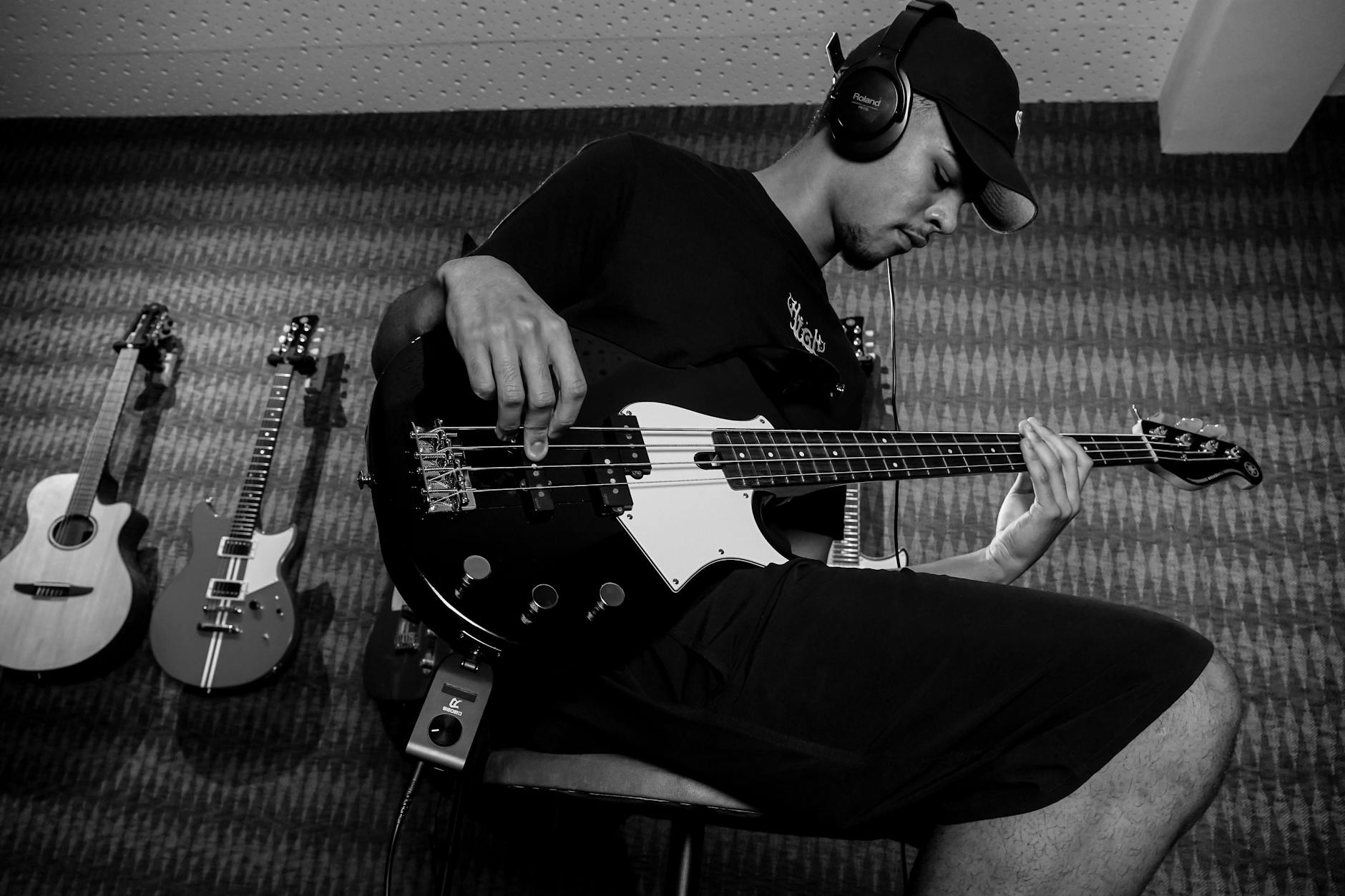 Musician wearing headphones while working at computer workstation