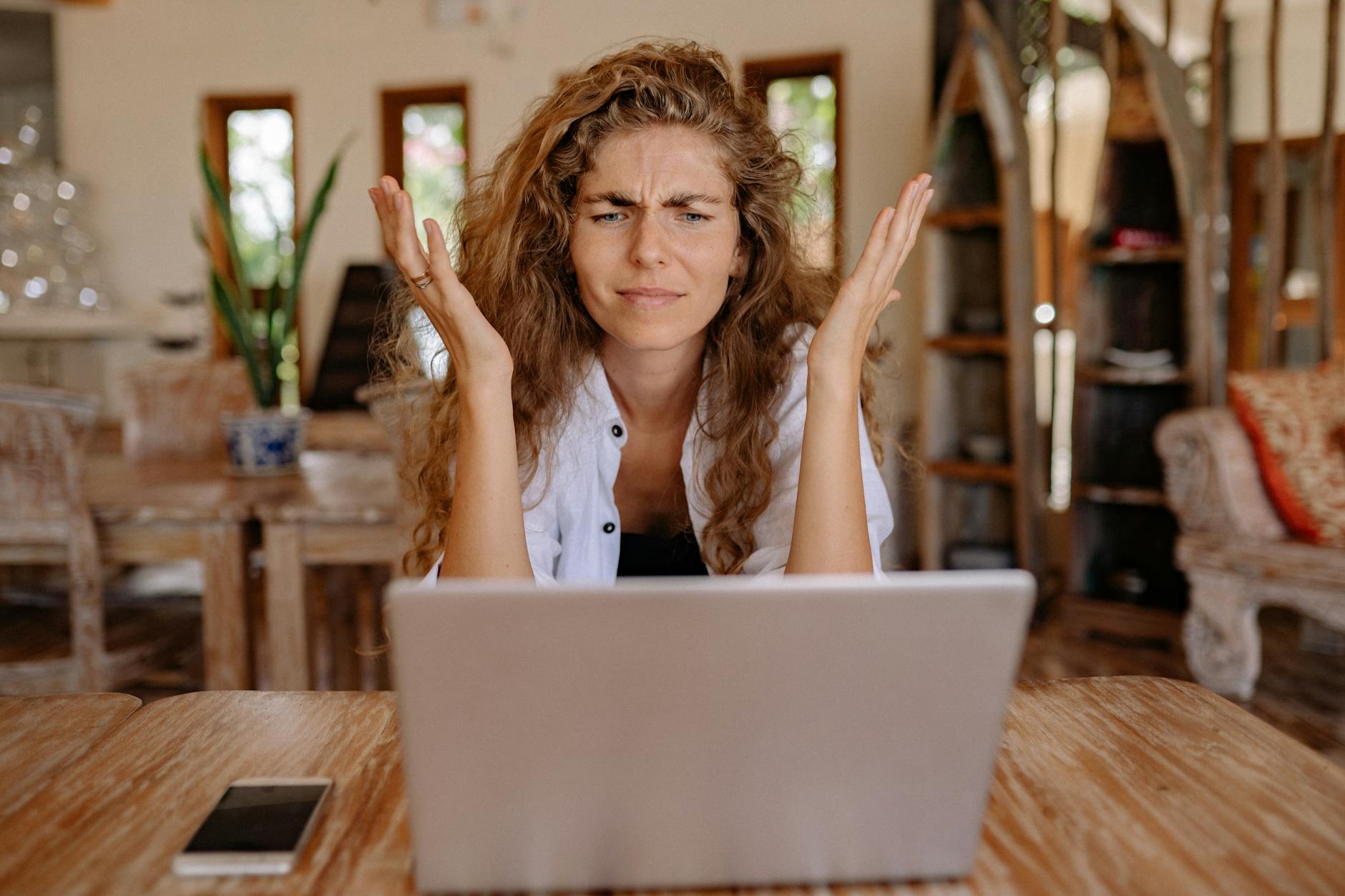 Concerned woman looking at computer screen in office setting