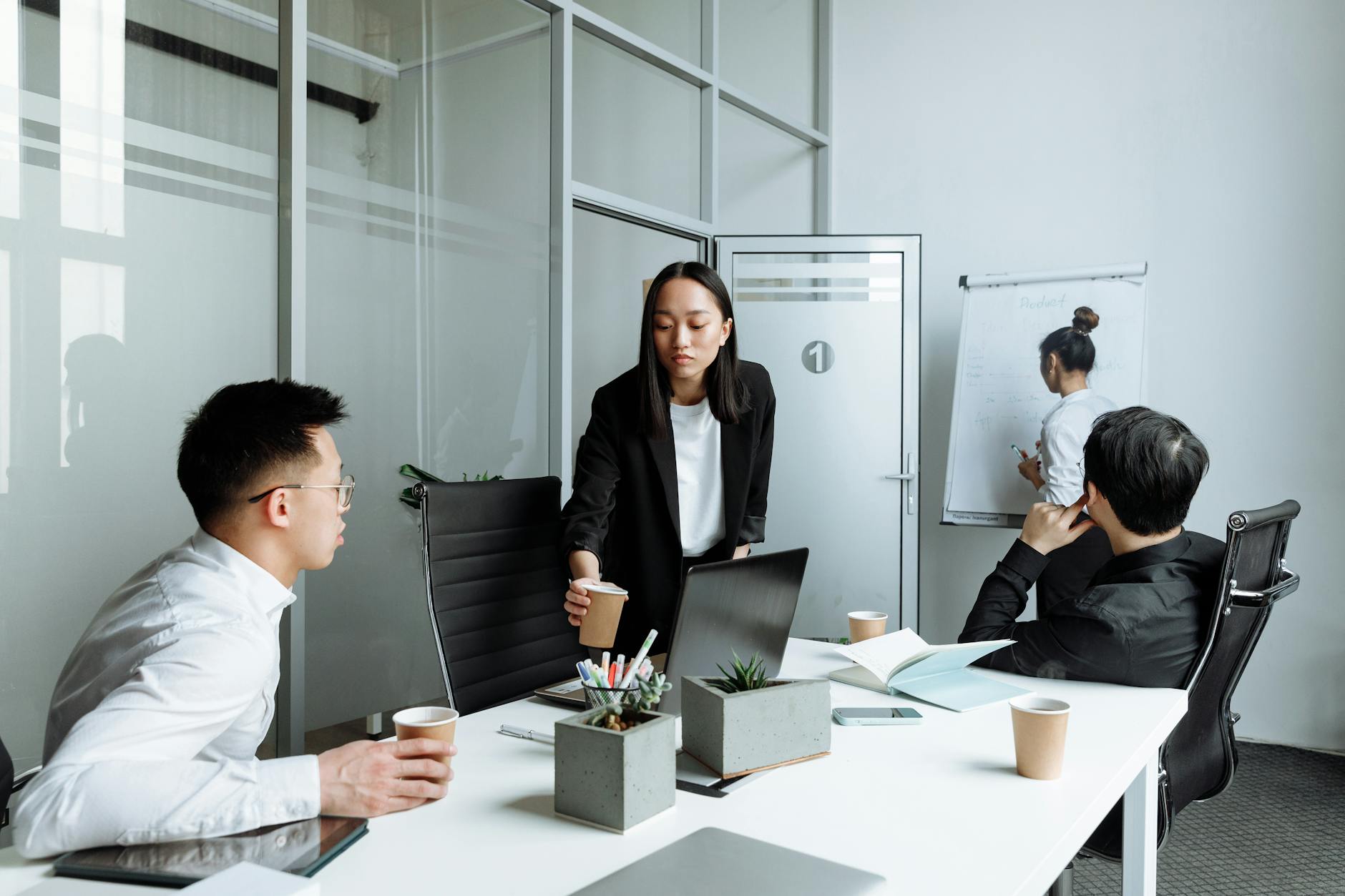 Design team collaborating around computer screen in modern office