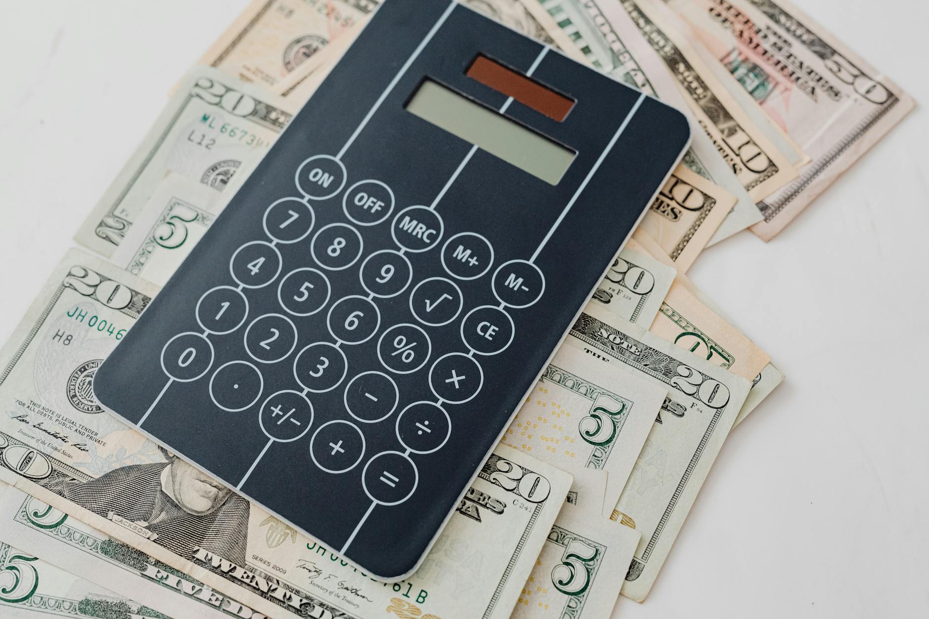 Calculator and money on desk representing creator income calculations and earnings