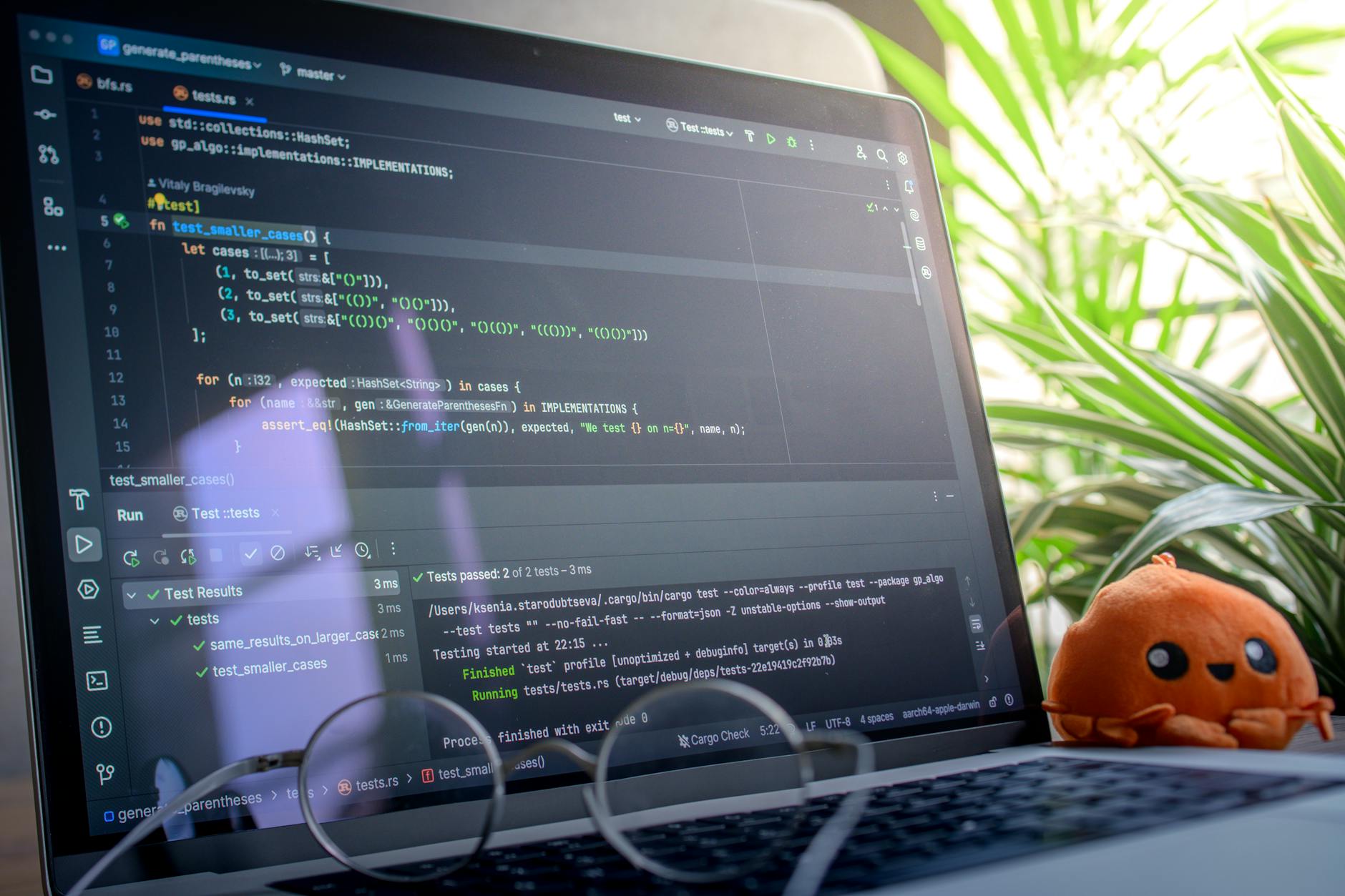 Developer working on laptop performing software testing and debugging tasks