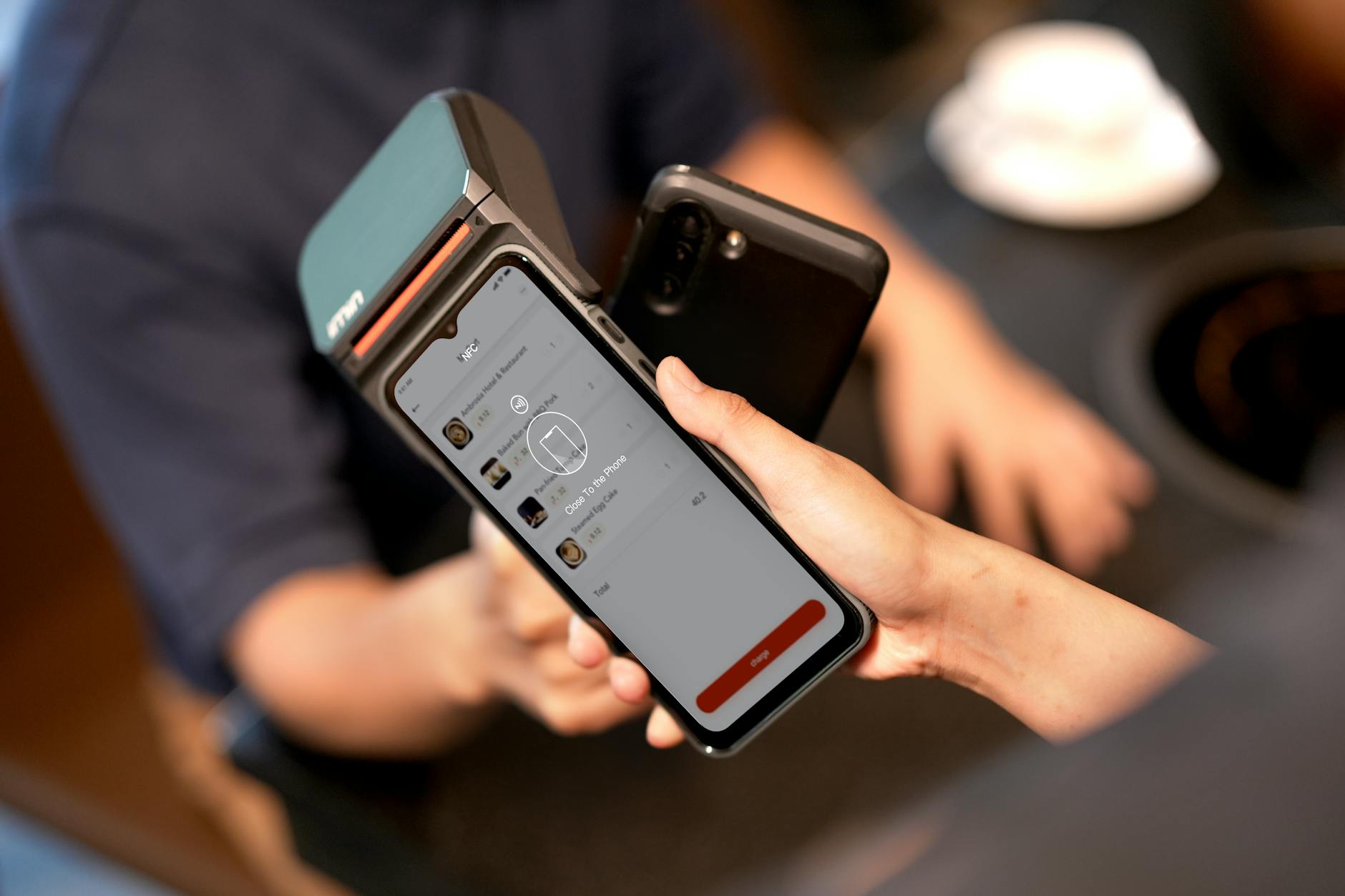 Hand holding smartphone displaying mobile payment interface