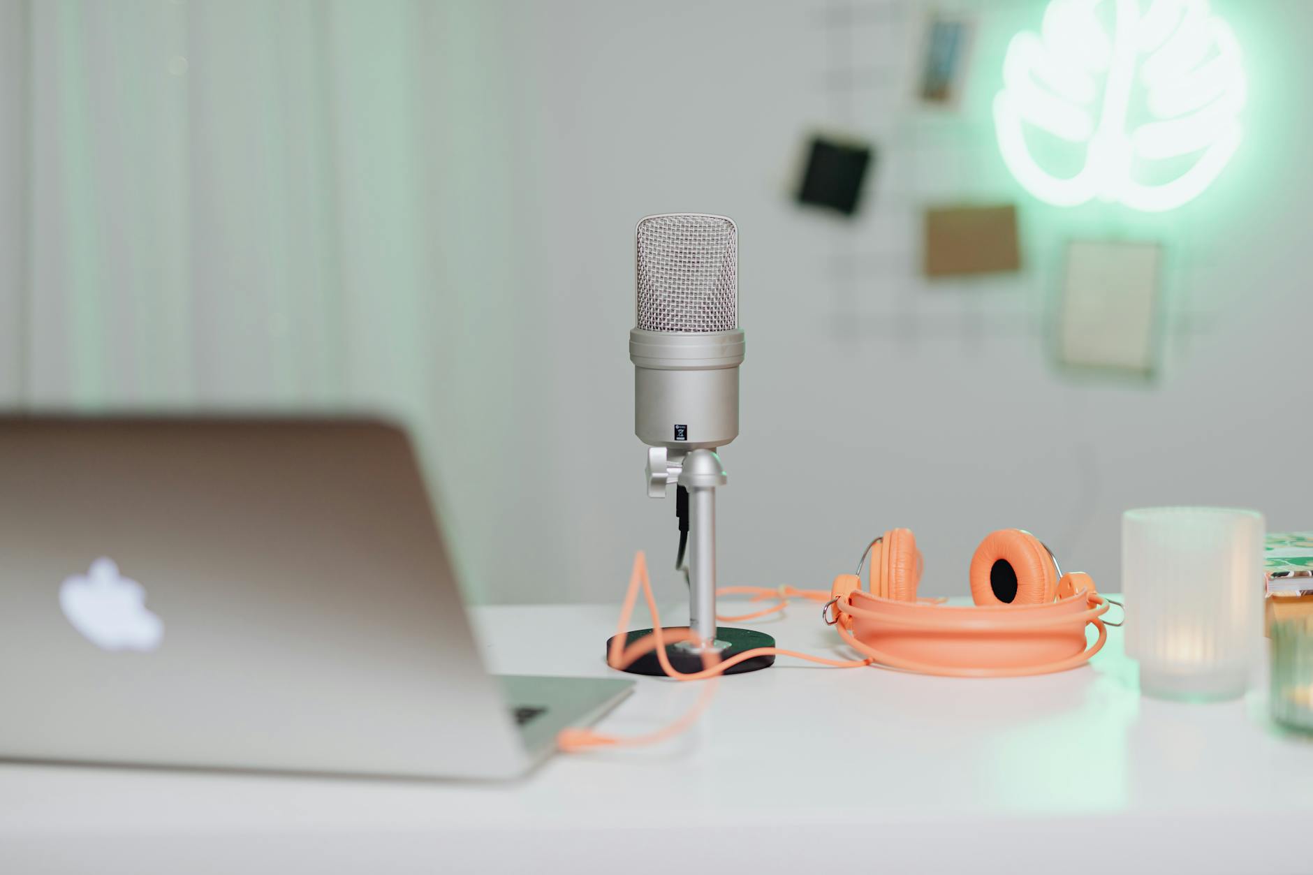 Podcast recording setup with headphones and microphone on desk