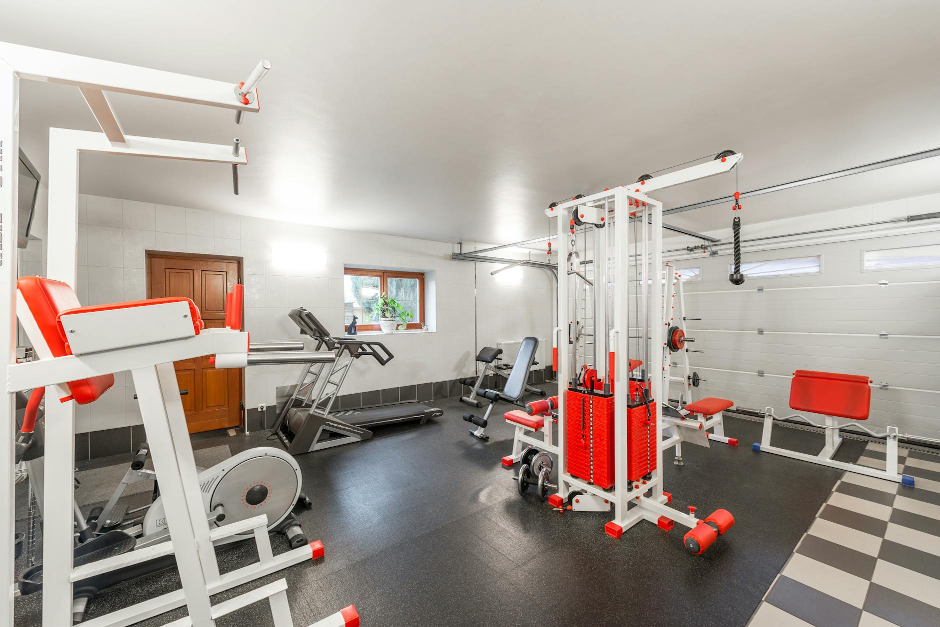 Modern home gym setup with various exercise equipment and technology