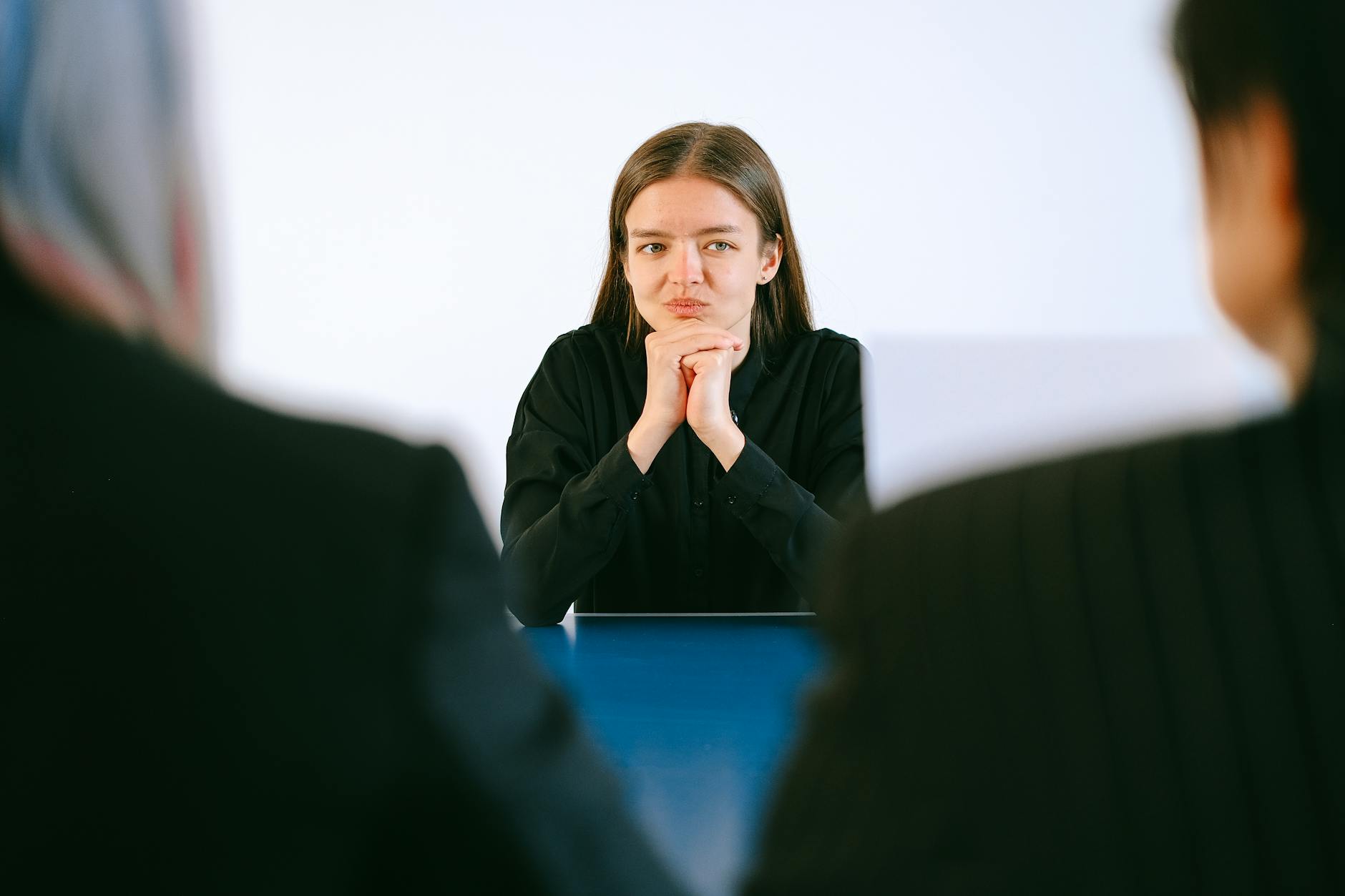 Professional job interview scene with candidate and interviewer at office table
