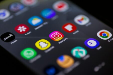 Instagram’s Creator Bonus Program Gets Major Overhaul After User Backlash Person holding smartphone displaying Instagram interface with creator tools and monetization features
