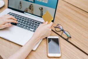 Person completing online purchase on laptop showing checkout screen
