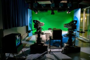 Small film production crew working on an indie movie set with cameras and lighting equipment