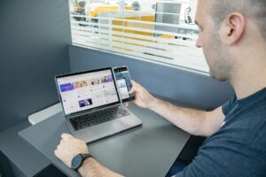 Modern office workspace with multiple screens showing productivity software