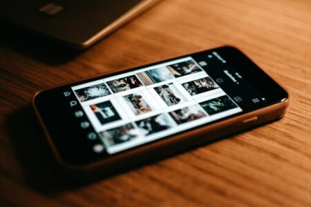 Bluesky’s Verification System Is Drawing Twitter Refugees Back to Text-Based Social Media Person holding smartphone displaying social media interface