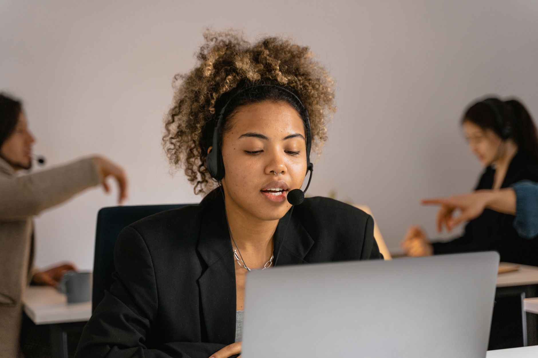 A customer support workstation with a computer screen and headset representing enterprise help desk operations