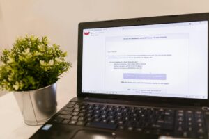 Close-up view of laptop screen displaying email interface with Gmail open