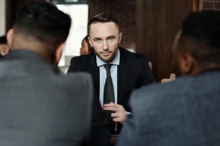 Corporate executives discussing technology implementation in conference room