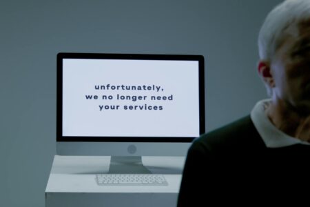 Empty office cubicles and desks representing workforce reduction