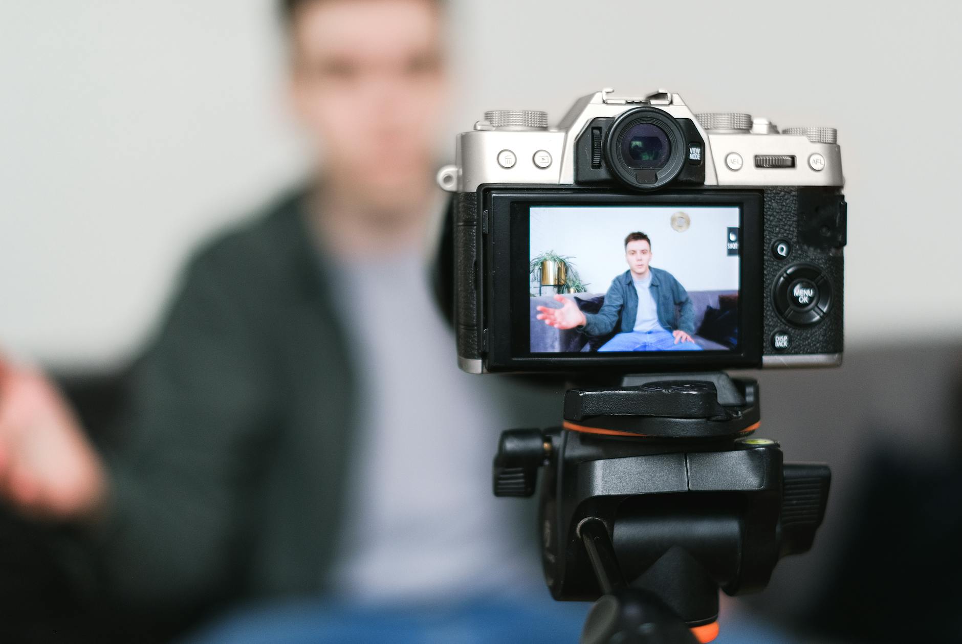 Social media content creator recording video content with ring light and camera equipment