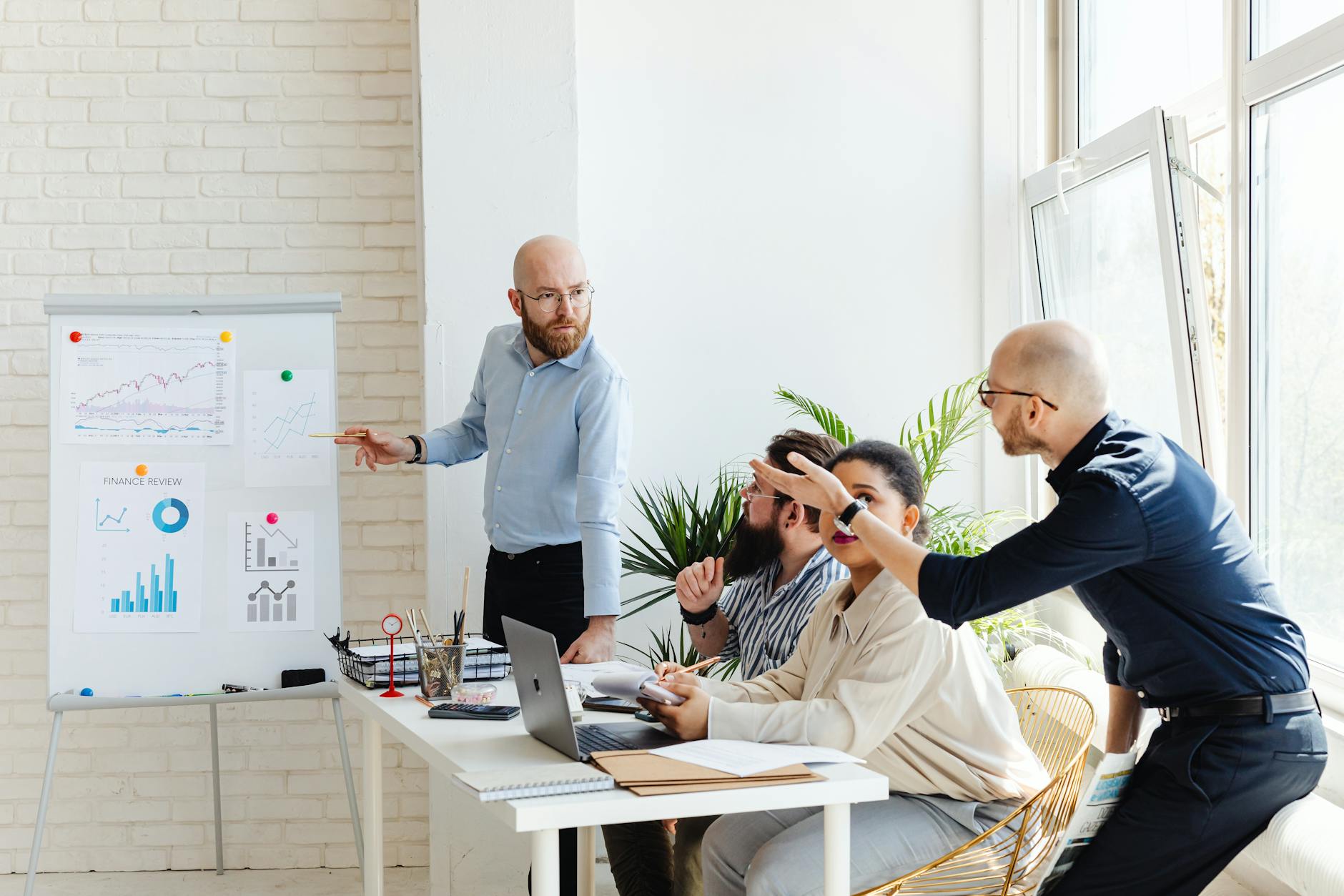 Team of professionals reviewing software dashboards in a corporate meeting room