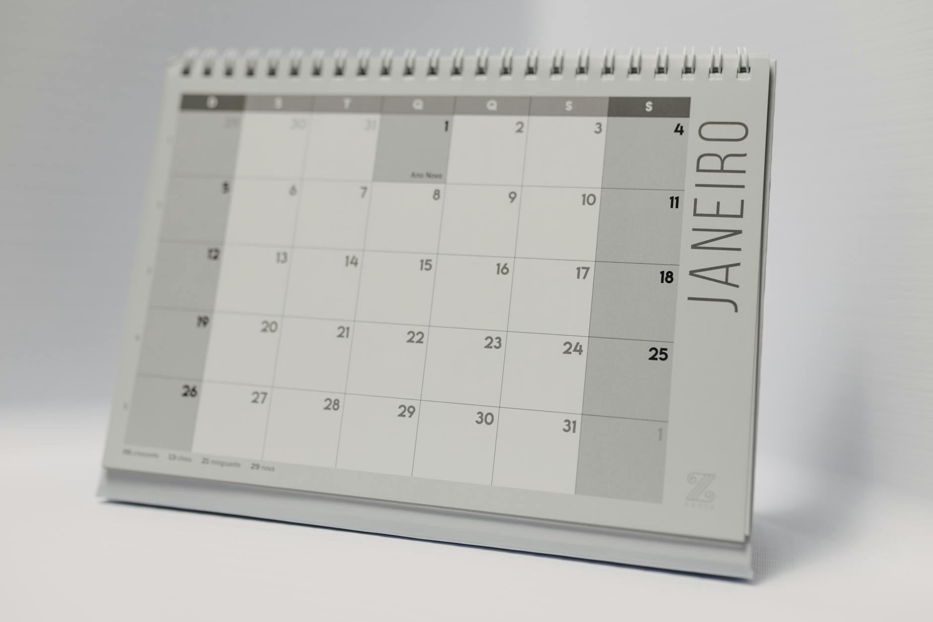 Business professional reviewing calendar and planning schedule at office desk