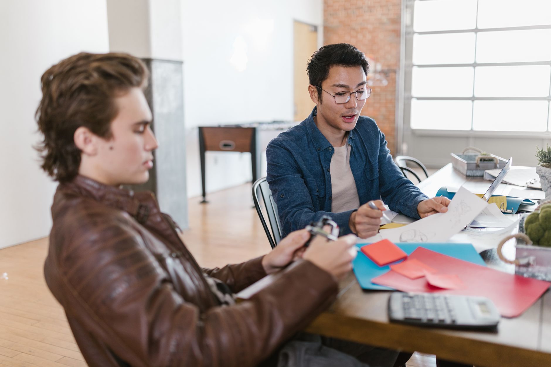 Team gathered around a table in a modern tech startup office