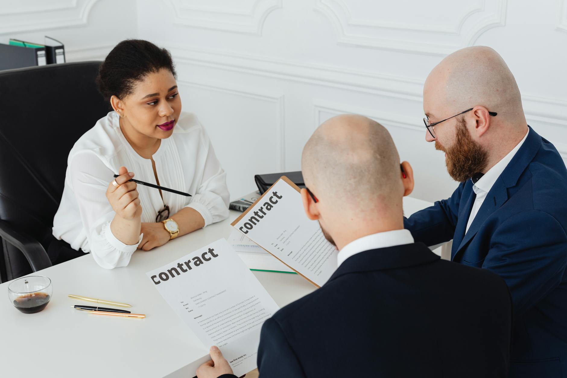 Two professionals reviewing documents at a meeting table representing enterprise software procurement decisions