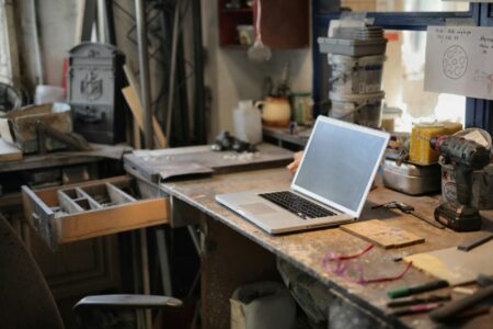 Person working on a laptop at a clean desk workspace representing productivity software use