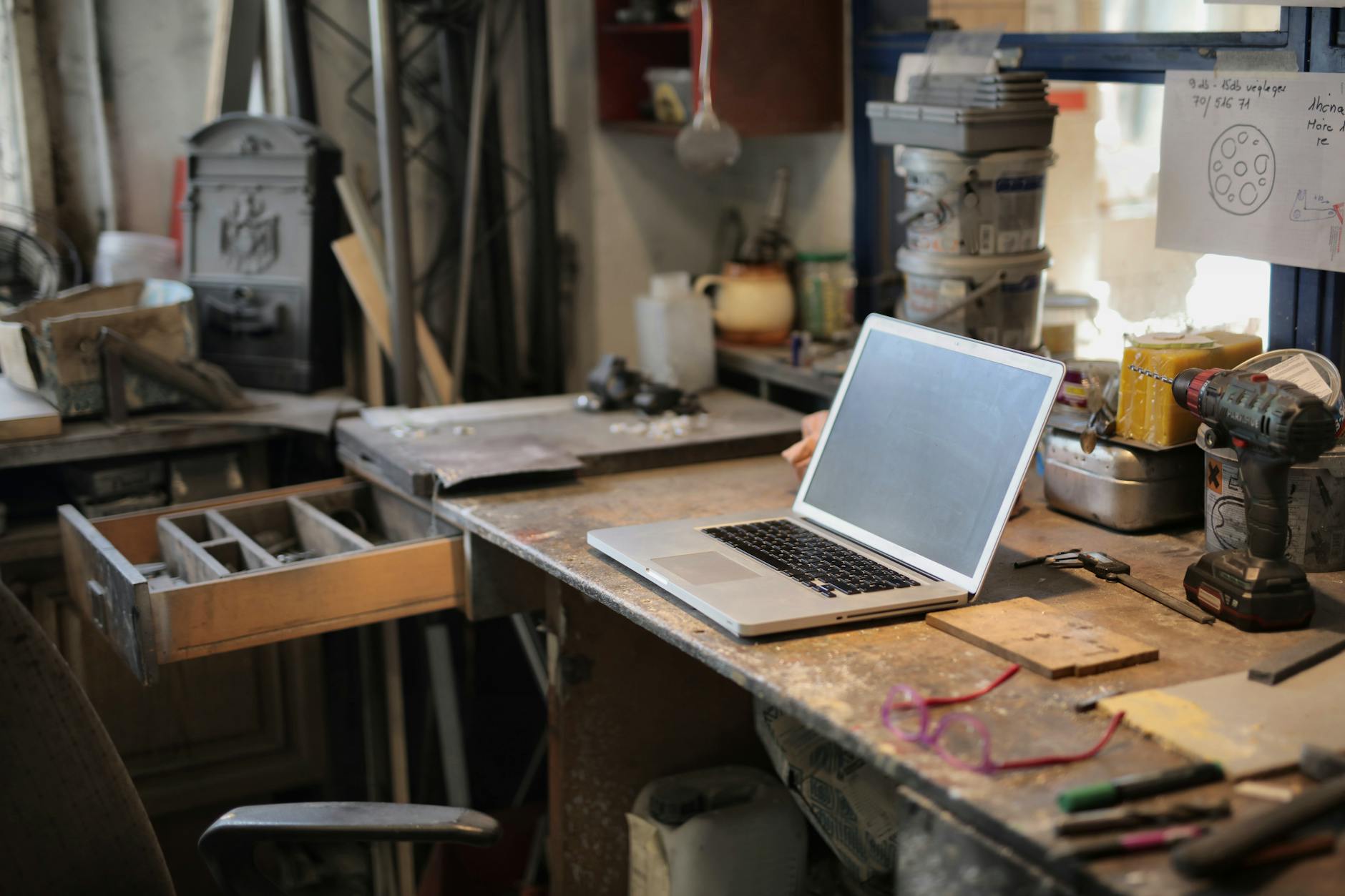 Person working on a laptop at a clean desk workspace representing productivity software use