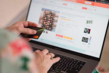 Person browsing and shopping online using a laptop computer