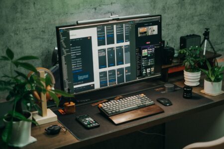 A modern workspace with a laptop and productivity tools representing no-code software competition