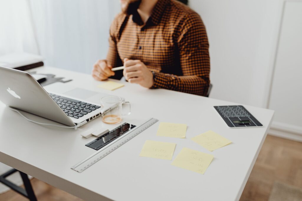 Notion’s AI Templates Are Squeezing Canva’s Docs Ambitions A clean office desk setup with a laptop open to a document workspace