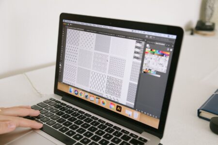 A designer working on a digital UI design tool interface on a modern computer screen