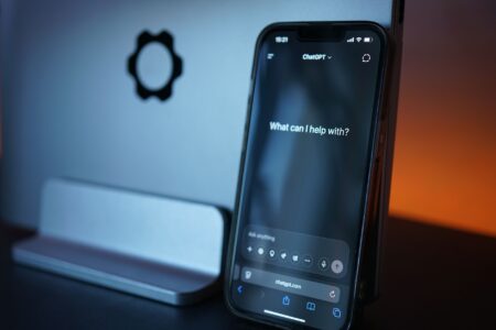 Person holding a smartphone using a voice assistant app