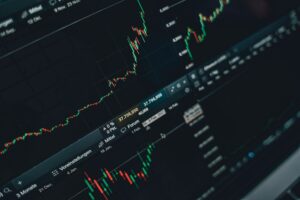 Trader monitors showing stock market data and fintech company valuations