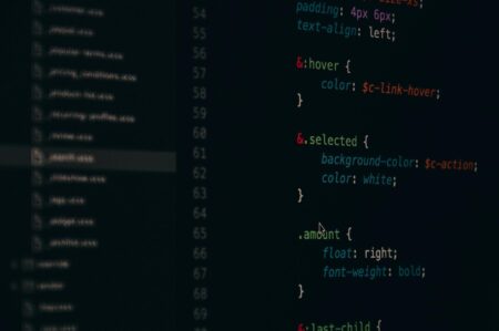 Developer working with a code editor on a desktop monitor