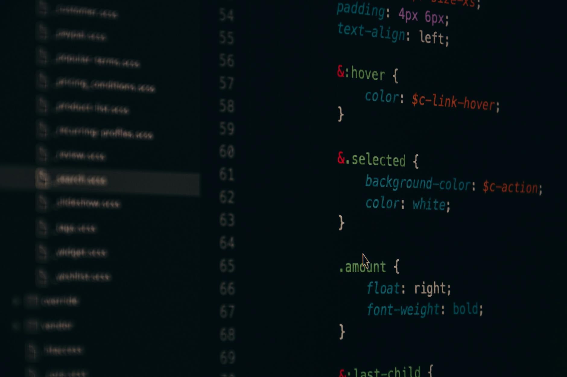 Developer working with a code editor on a desktop monitor