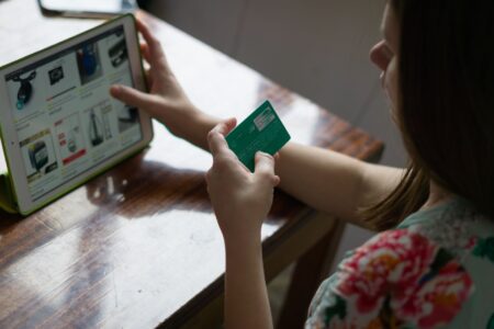 Bolt’s Checkout Platform Is Chipping Away at Shopify’s Payments Grip Person completing a purchase on a laptop at an online checkout screen